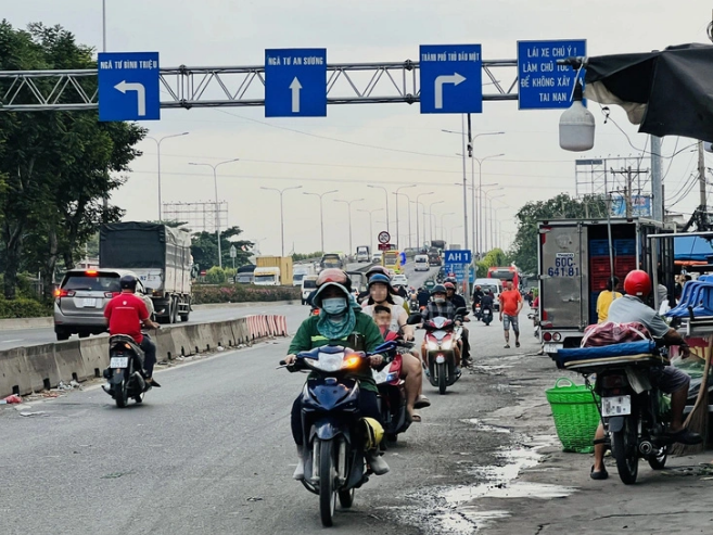 Motorbike riders queue up to run in the wrong direction in front of the Thu Duc Wholesale Market in Thu Duc City, under Ho Chi Minh City. Photo: Xuan Doan / Tuoi Tre