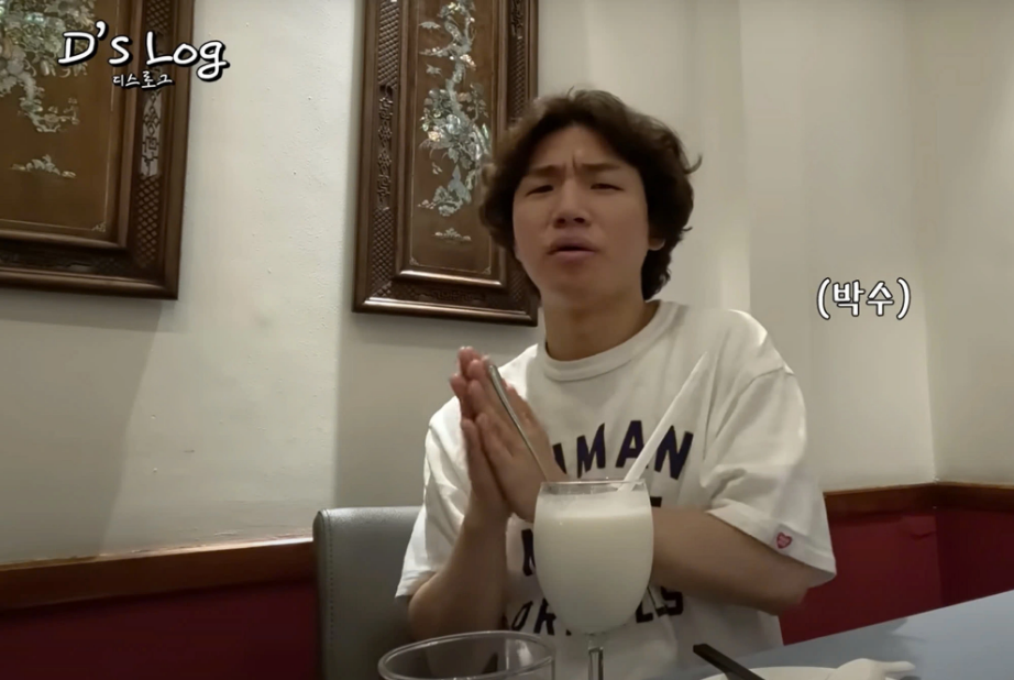 Daesung claps for a coconut smoothie at a restaurant in Ho Chi Minh City