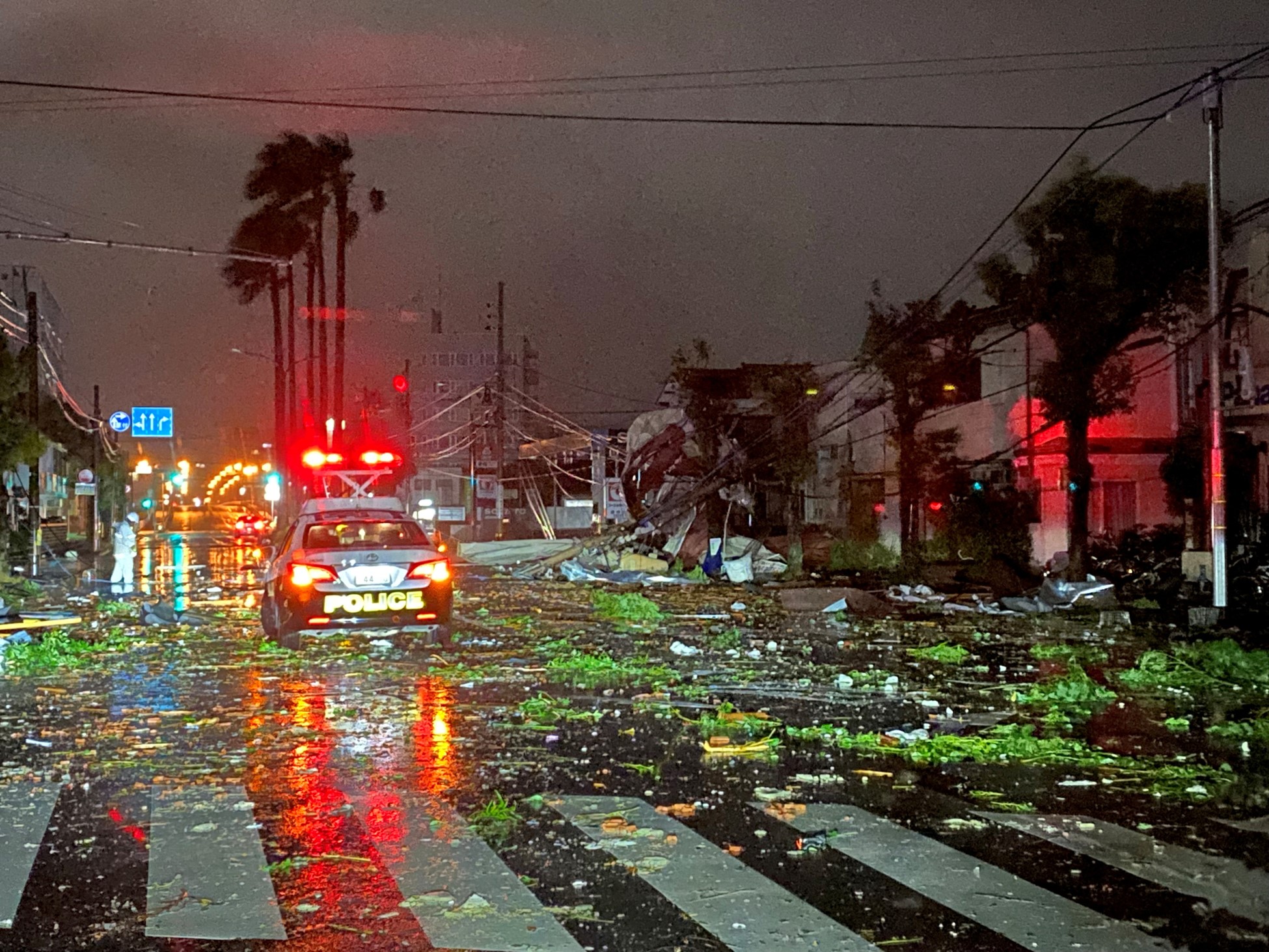 A police car drives amid destruction from Typhoon Shanshan in Miyazaki city, Japan August 29, 2024.