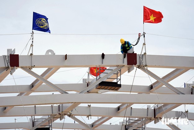 Contractors install the steel frame of the roof of the passenger terminal.