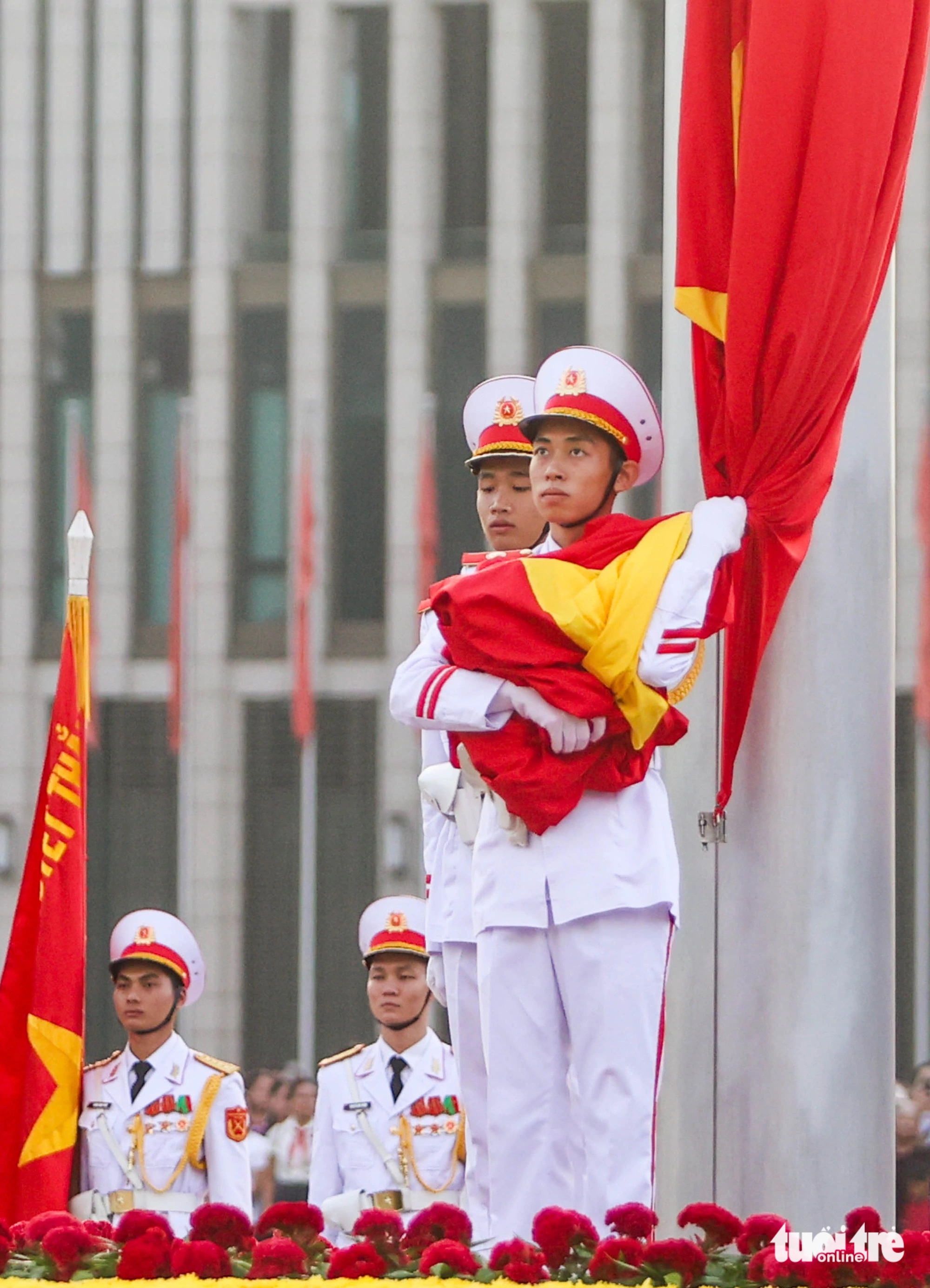 A soldier hugs the Vietnamese national flag, waiting for the national anthem to play during a flag-raising ceremony in celebration of Vietnam’s 79th National Day at Ba Dinh Square in Hanoi, September 2, 2024. Photo: Nguyen Khanh / Tuoi Tre