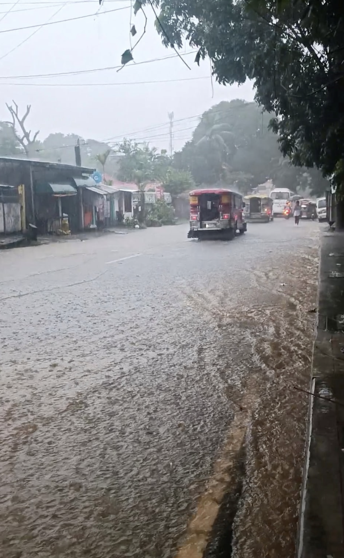 Traffic moves through a flooded street in Antipolo, Rizal, just outside the Philippines' capital, Septemer 2, 2024 in this still image obtained from social media video. Photo: Reuters