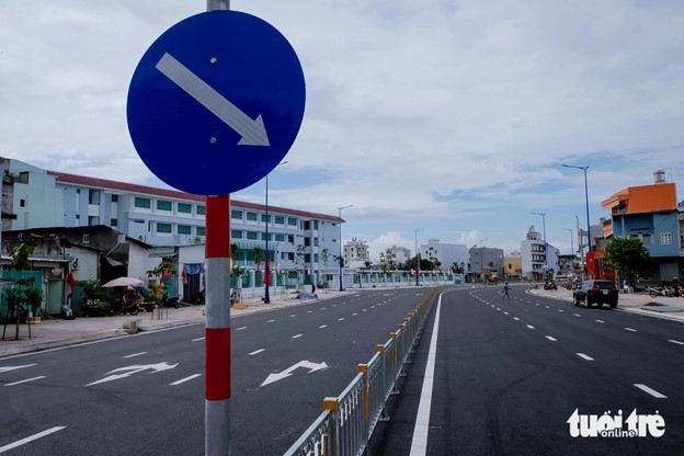 Traffic signs and lights have been installed on the extended street section.