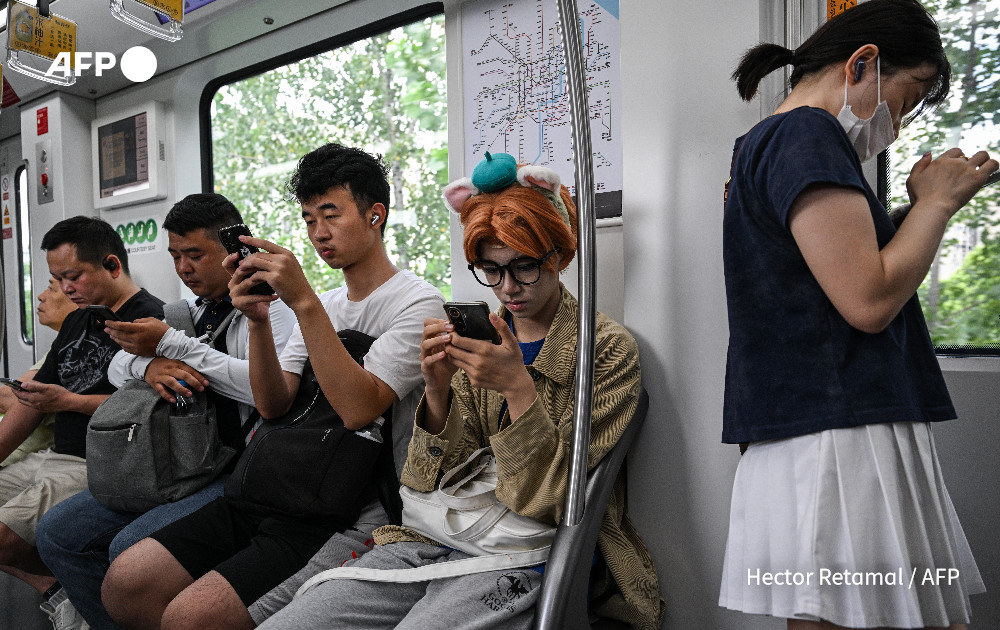 This photo taken on August 14, 2024 shows cosplayer Xu Yunting (C), dressed as Jesse, a male character from the video game 'Light and Night', riding the metro before going on a 'cos commissioning' date in Shanghai. Photo: AFP