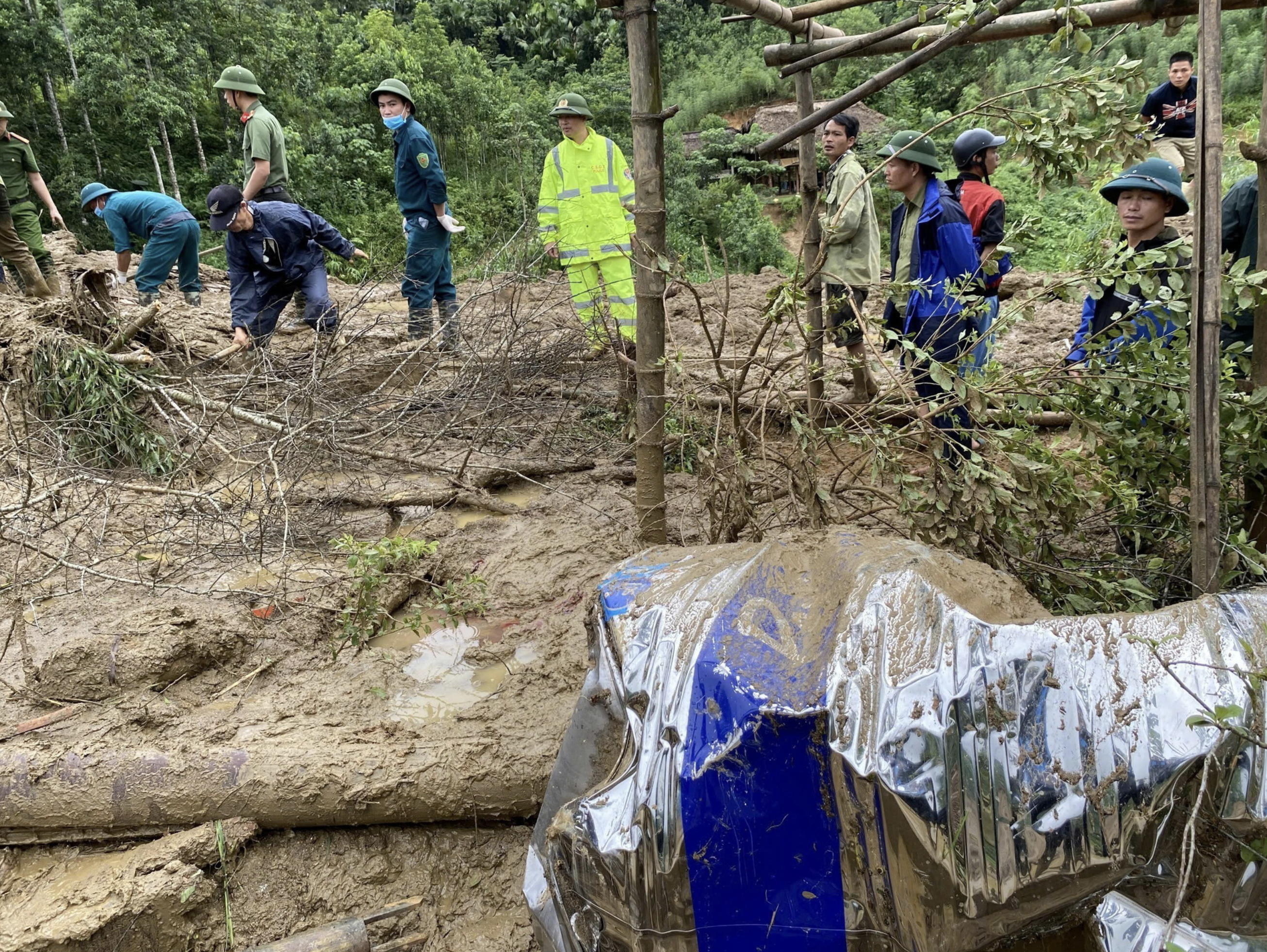 Rescuers are pictured searching for those missing from a flash flood in Lao Cai Province. Photo: Vietnam News Agency