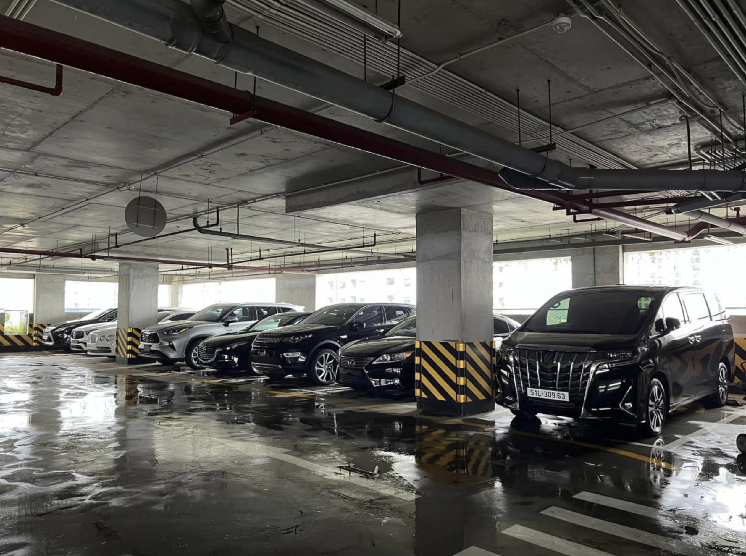 Supercars relocated to a higher floor of an auto showroom in Hanoi. Photo: Ha Dat