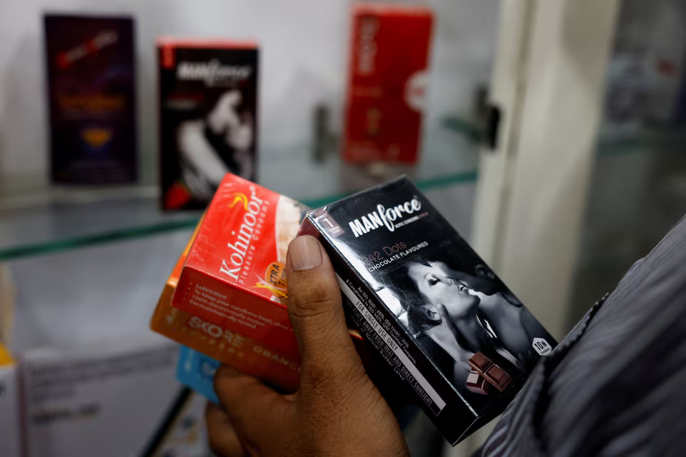 A man selects packets of condoms that are displayed for sale at a chemist shop in Ahmedabad, India, September 2, 2024. Photo: Reuters