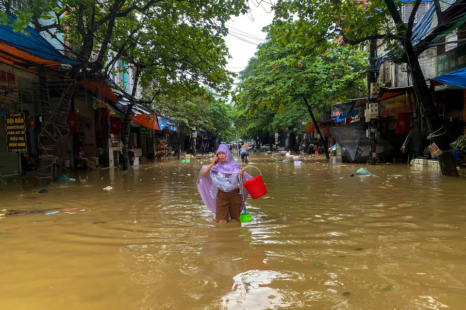 A woman wades through a flooded street following the impact of Typhoon Yagi in Thai Nguyen City, Vietnam, September 11, 2024. Photo: Reuters