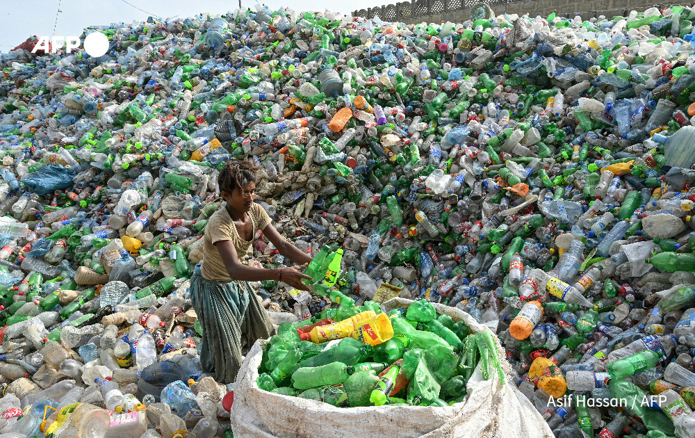 A worker sorts used plastic bottles at a recycling unit in Karachi on September 12, 2024. Photo: AFP