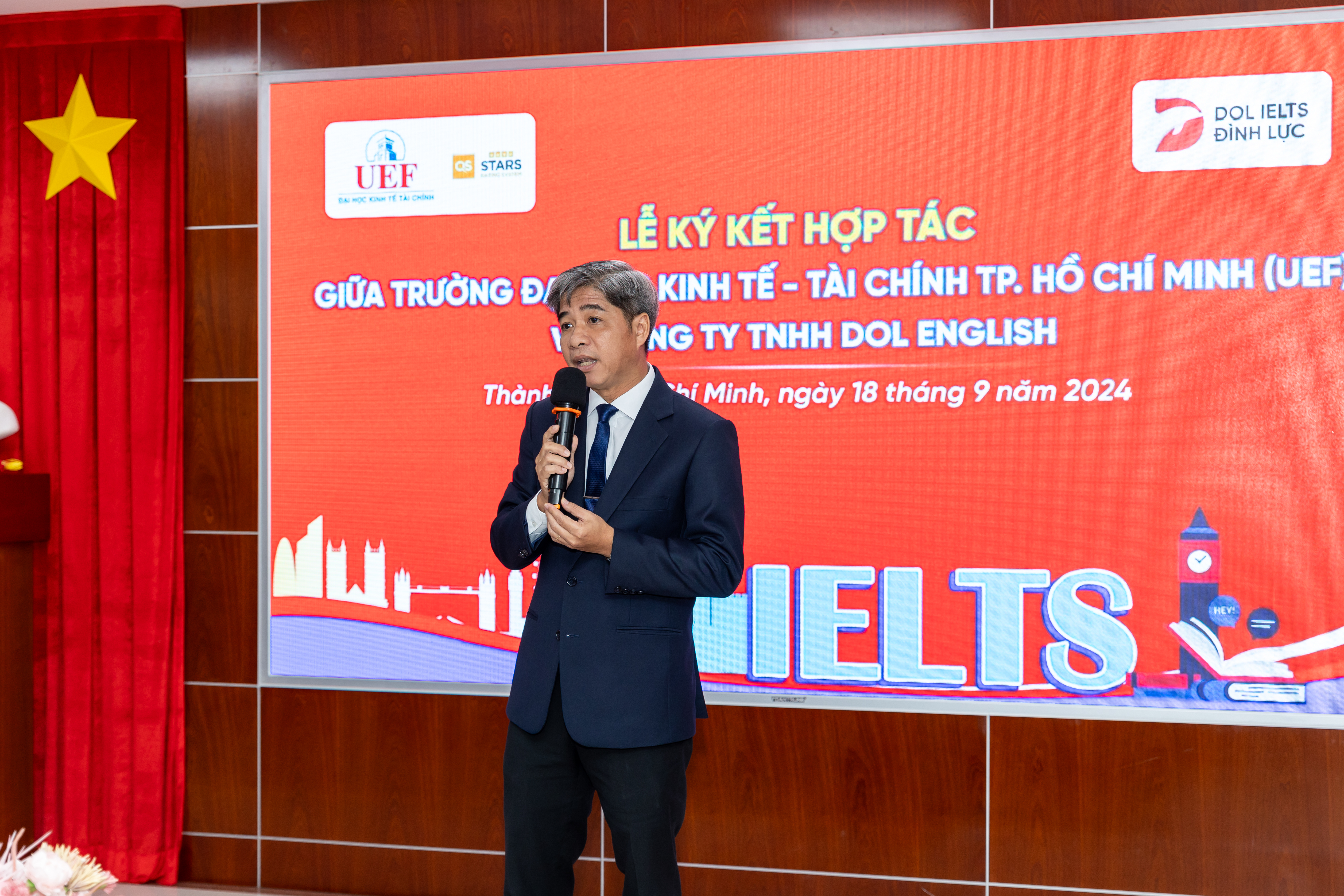 Dr. Nguyen Thanh Giang, president of the Ho Chi Minh City University of Economics and Finance, speaks at the ceremony to sign a partnership agreement between his school and DOL English in Ho Chi Minh City, September 18, 2024.