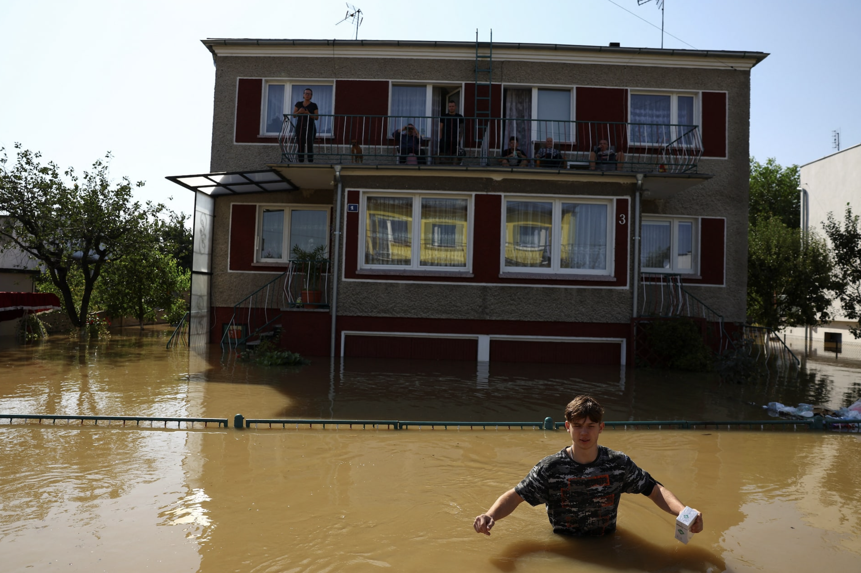 A person walks through floodwater, in an area flooded by the Nysa Klodzka river, following heavy rainfalls, in Lewin Brzeski, Poland, September 17, 2024. Photo: Reuters