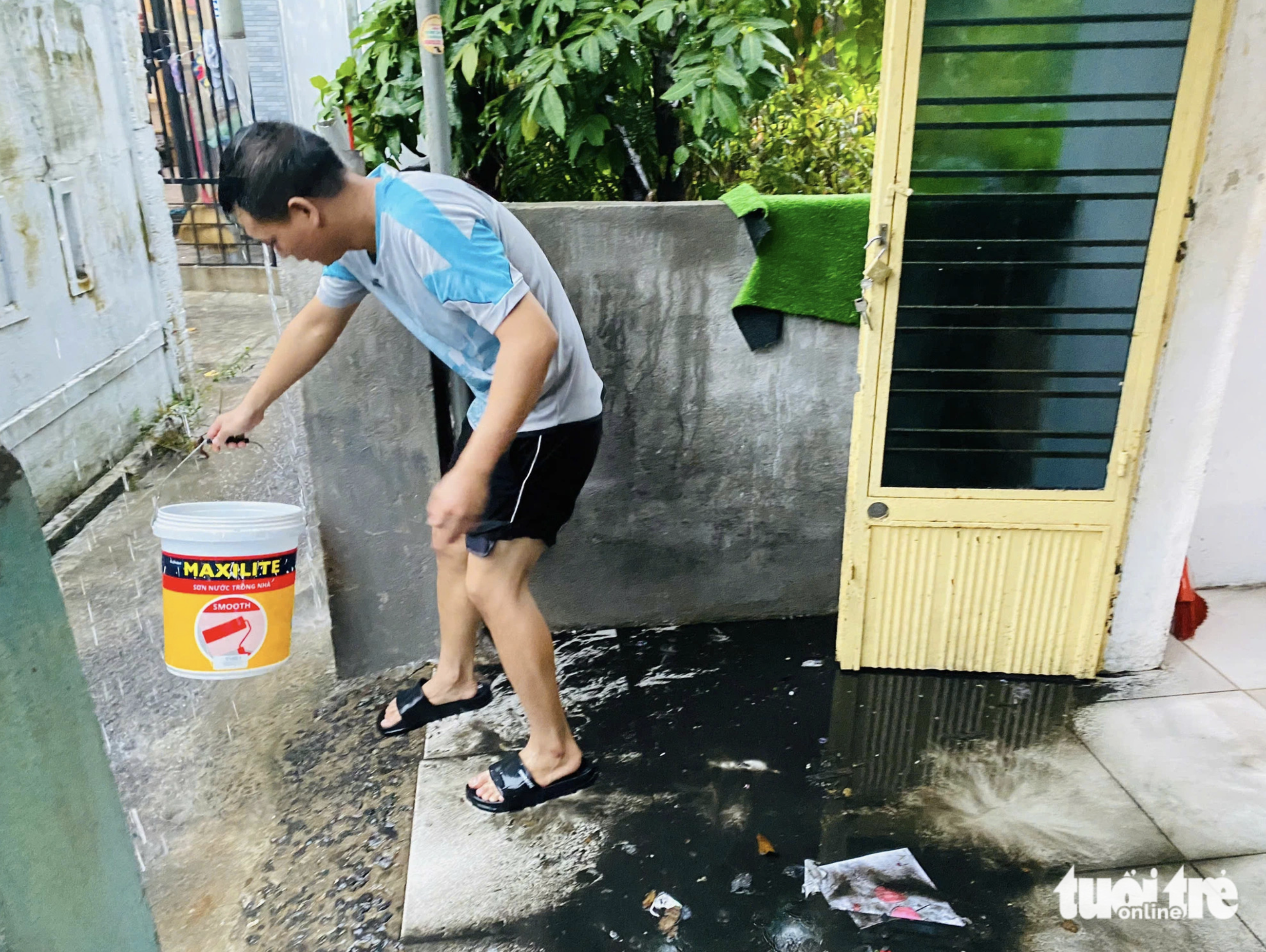 A man cleans his house after blackish water soaks his residence in Da Nang City. Photo: Doan Nhan / Tuoi Tre