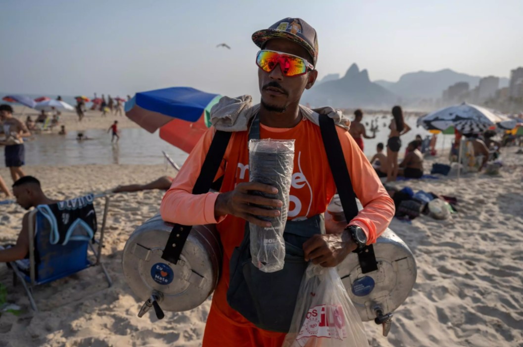 Vendors walk the beaches of Rio de Janeiro, lugging metal containers filled with the tea-like drink mate and stacks of plastic cups. Photo: AFP