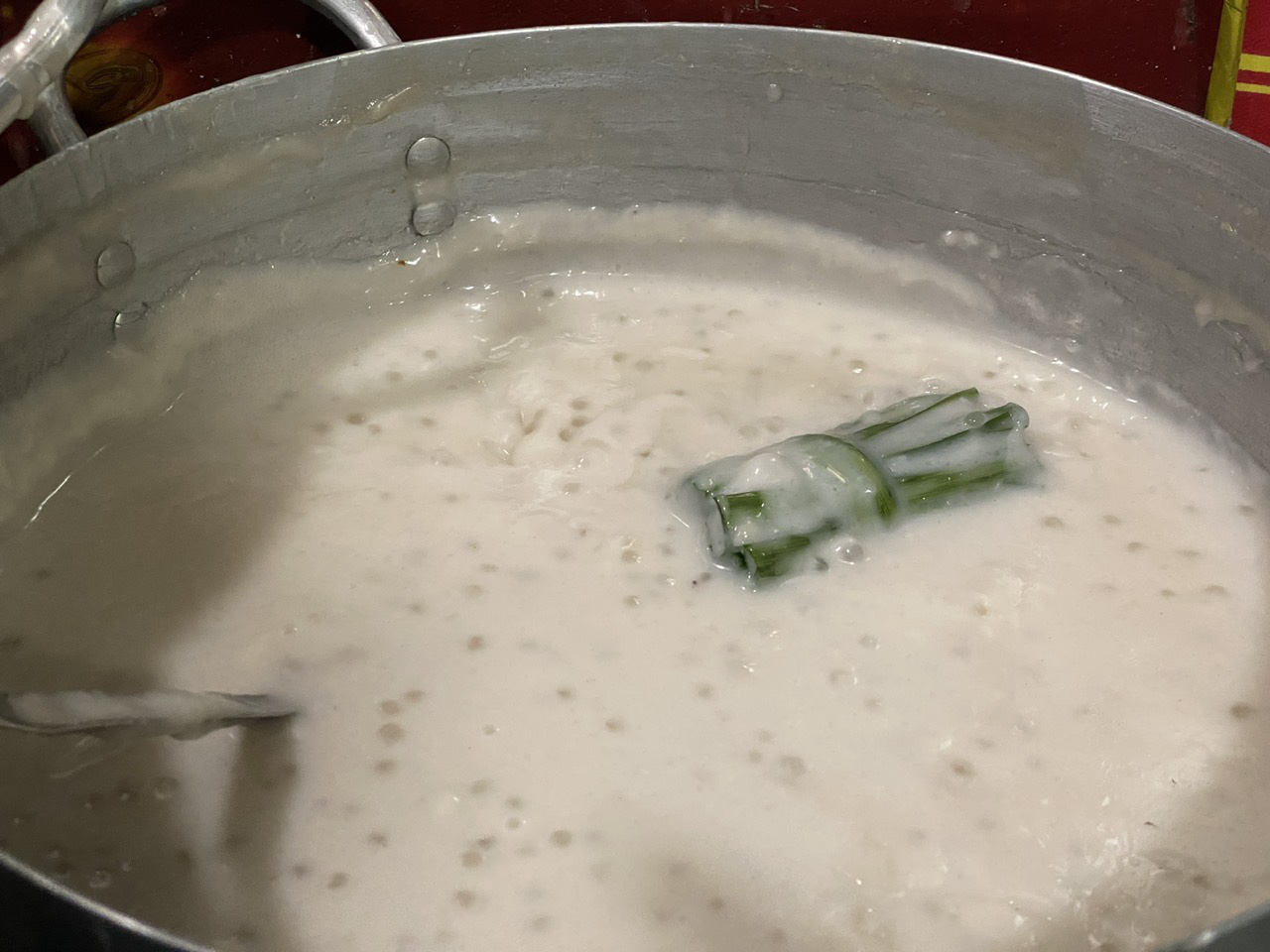 A pot of coconut milk simmered with pandan leaves. Photo: Dang Khuong / Tuoi Tre