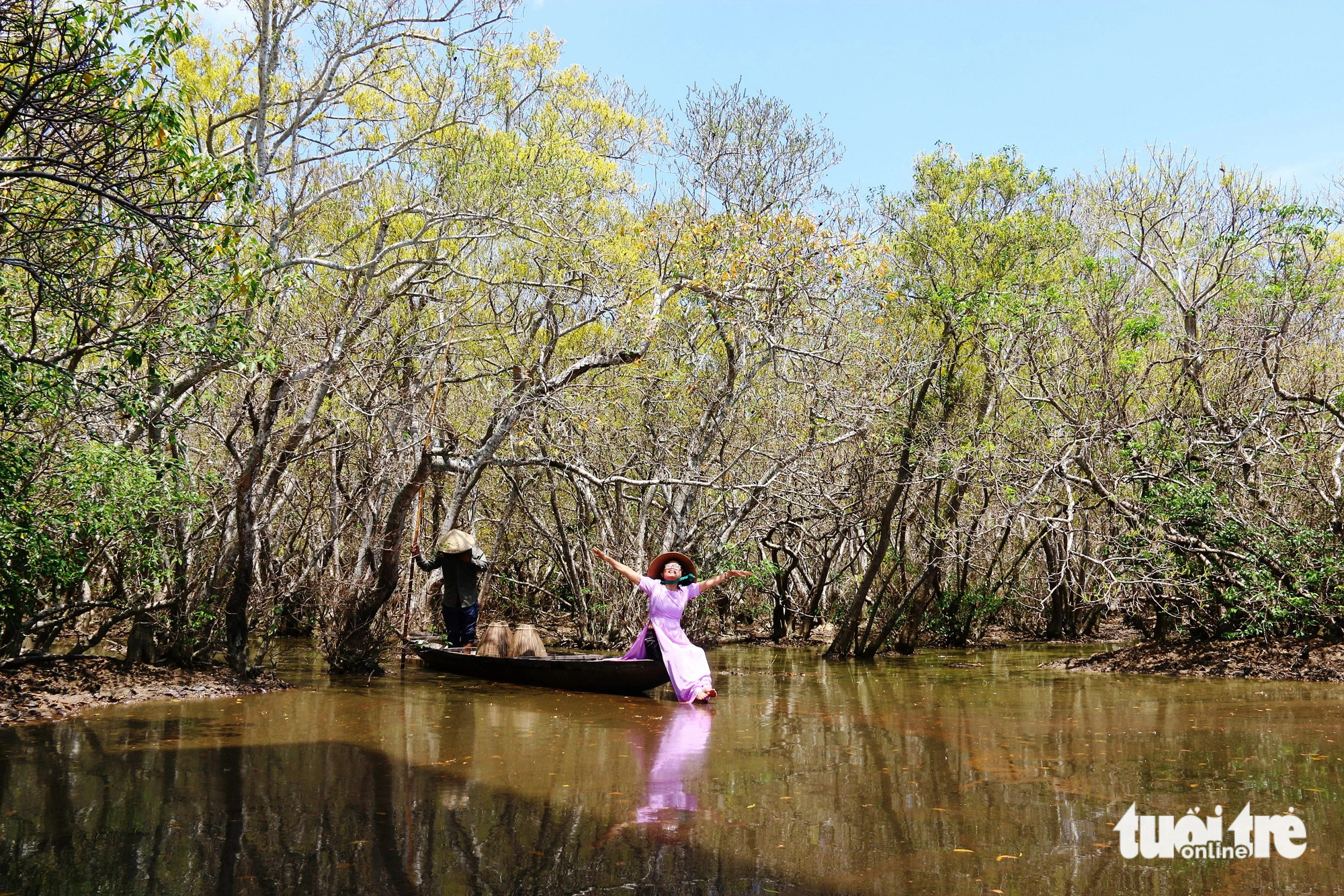 A woman poses for a photo in the Ru Cha primeval mangrove forest in the Tam Giang - Cau Hai lagoon, located in Thua Thien-Hue Province in central Vietnam. Photo: Nhat Linh / Tuoi Tre