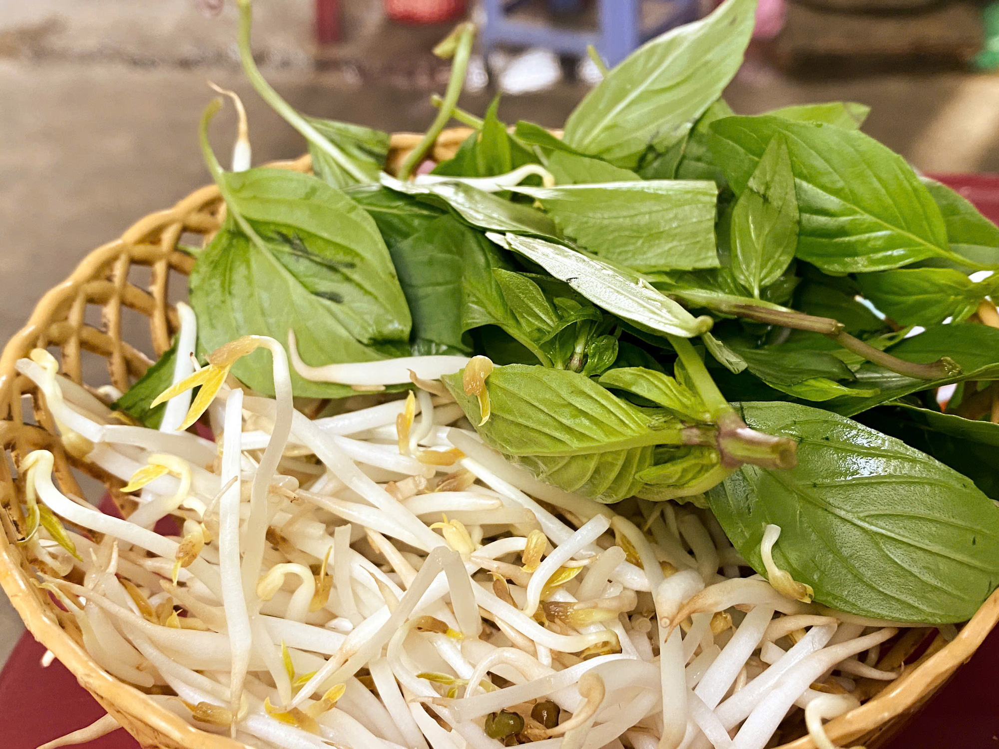 Herbs, coriander, and bean sprouts are eaten with Sau Ngoc Lam Son’s Vietnamese-Indian beef stew. Photo: Dang Khuong / Tuoi Tre