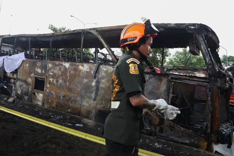 Firefighters work to extinguish a burning bus that was carrying teachers and students from Wat Khao Phraya school, reportedly killing almost a dozen, on the outskirts of Bangkok, Thailand, October 1, 2024. Photo: Reuters