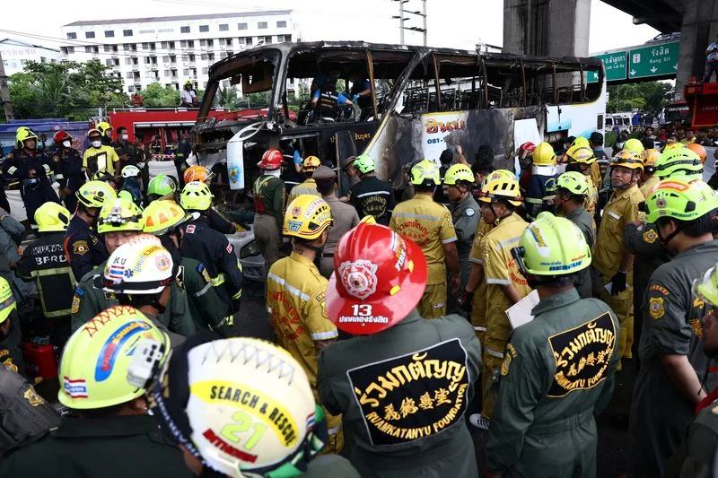 Firefighters work to extinguish a burning bus that was carrying teachers and students from Wat Khao Phraya school, reportedly killing almost a dozen, on the outskirts of Bangkok, Thailand, October 1, 2024. Photo: Reuters