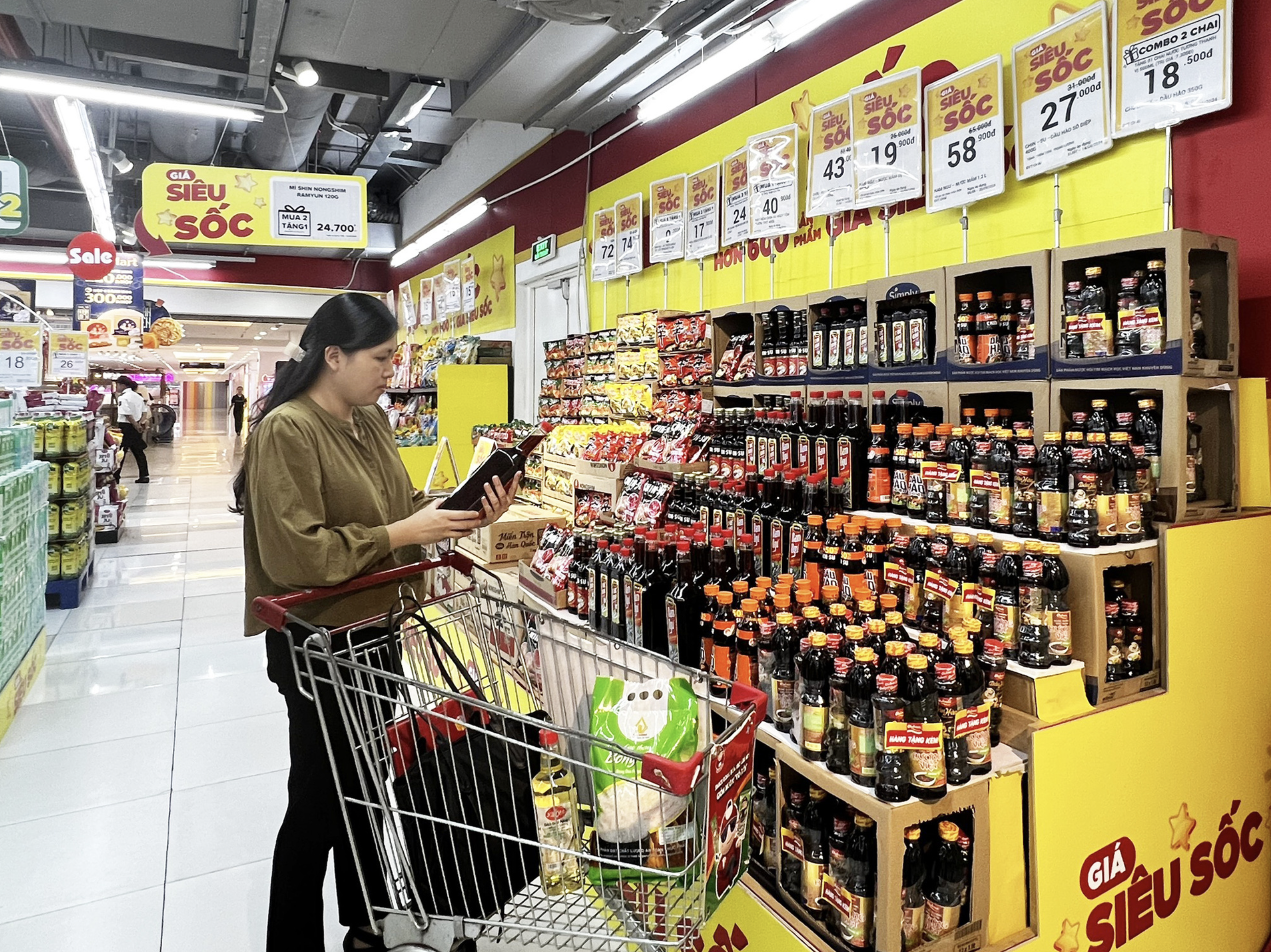 A customer selects Masan Consumer products at a WinMart supermarket