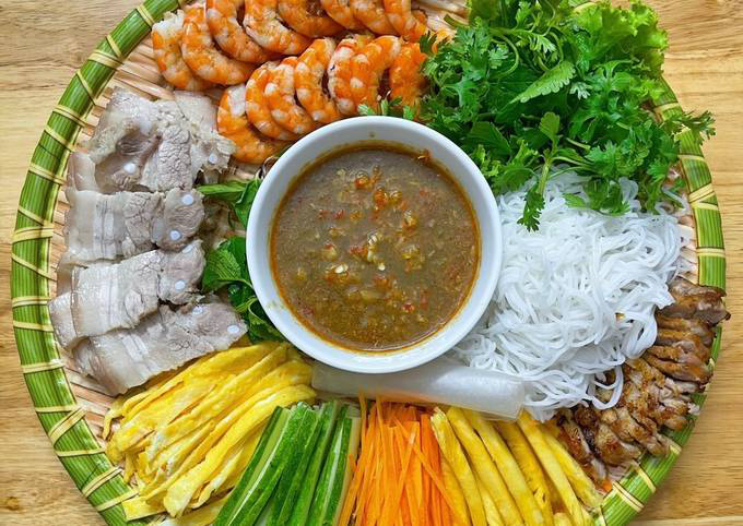 Vietnam's fermented fish sauce is served with rice paper rolls, which include vermicelli, meat, shrimp, and an assortment of fresh vegetables.