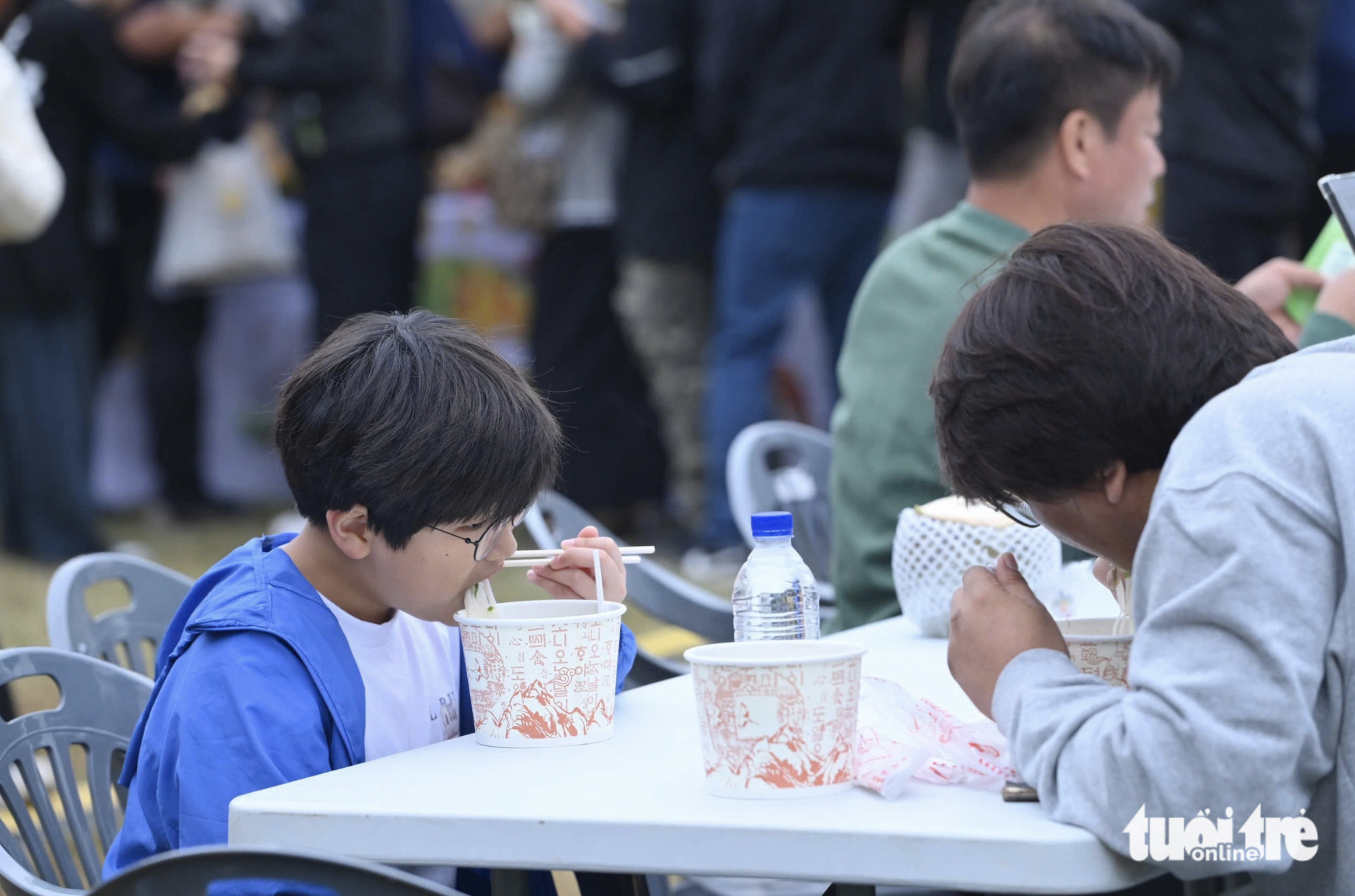 A man and a boy savor bowls of phở at the Vietnam Phở Festival 2024 in Seoul