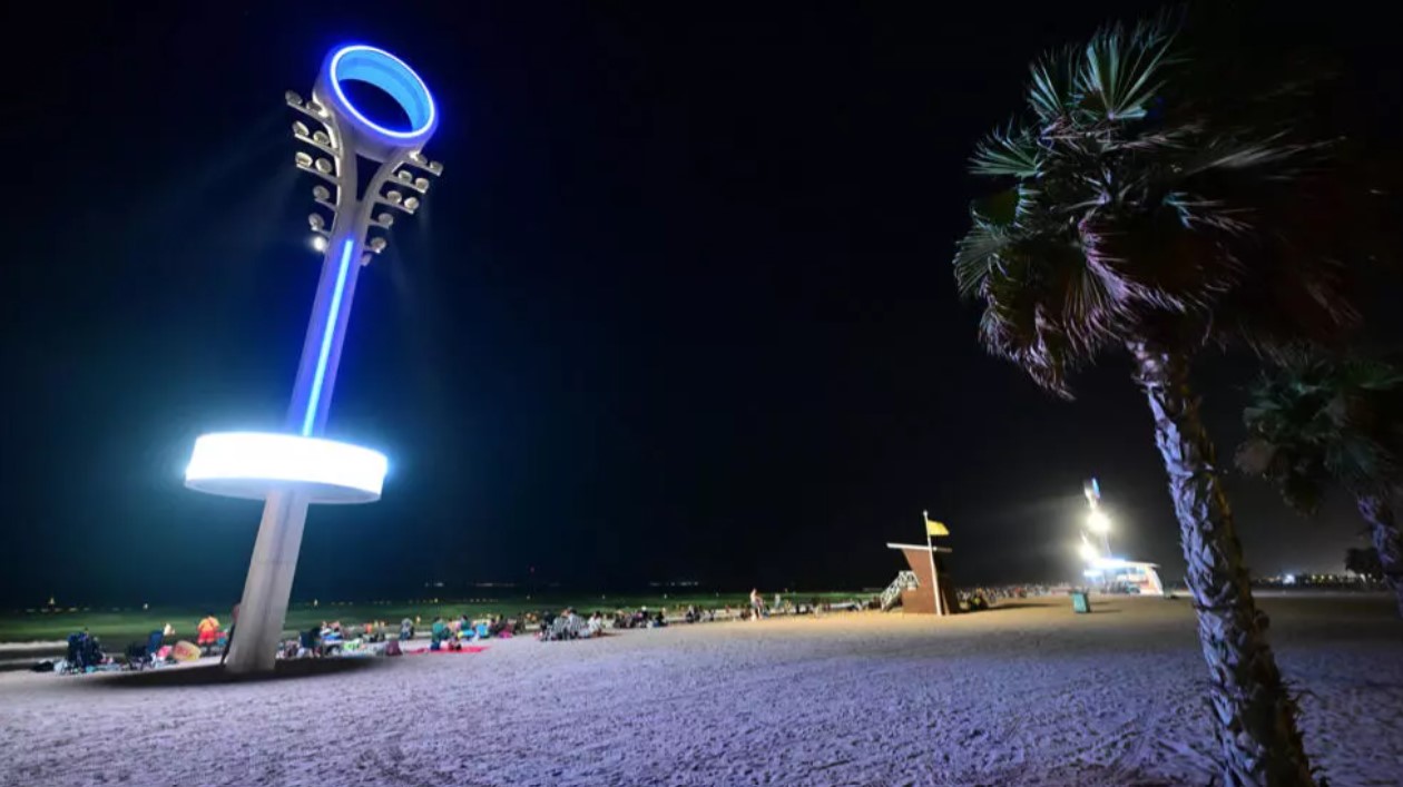 Too hot by day, Dubai's floodlit beaches are packed at night