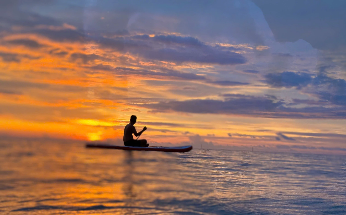 A visitor sits on a boat watching the sunset at Mui Ca Mau (Ca Mau Cape) National Park in Ca Mau Province, southern Vietnam. Photo: Thanh Huyen / Tuoi Tre