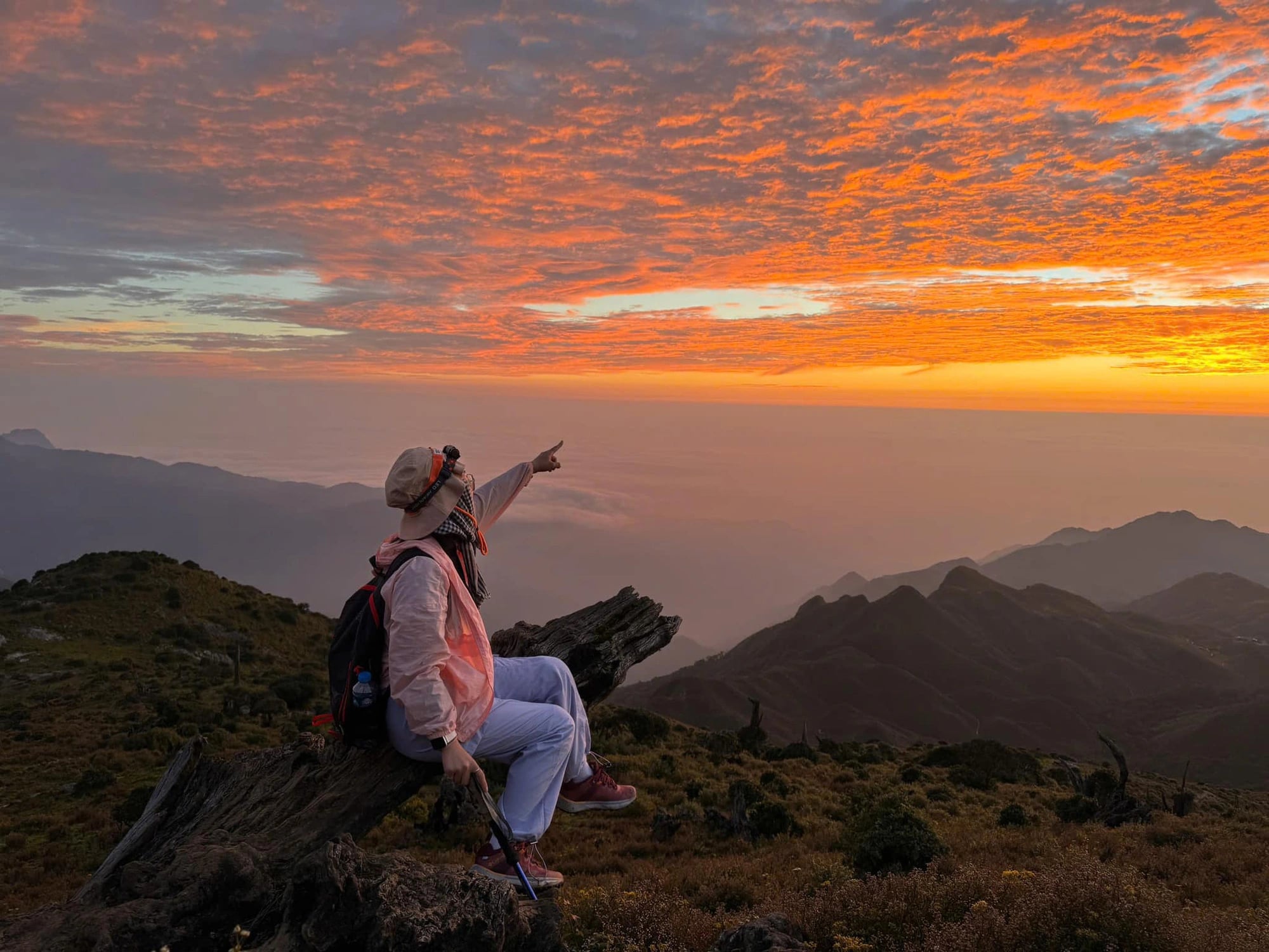 A visitor admires the stunning scene along her trekking route to Ta Chi Nhu Peak in Tram Tau District, Yen Bai Province, northern Vietnam. Photo: Hoang Gia