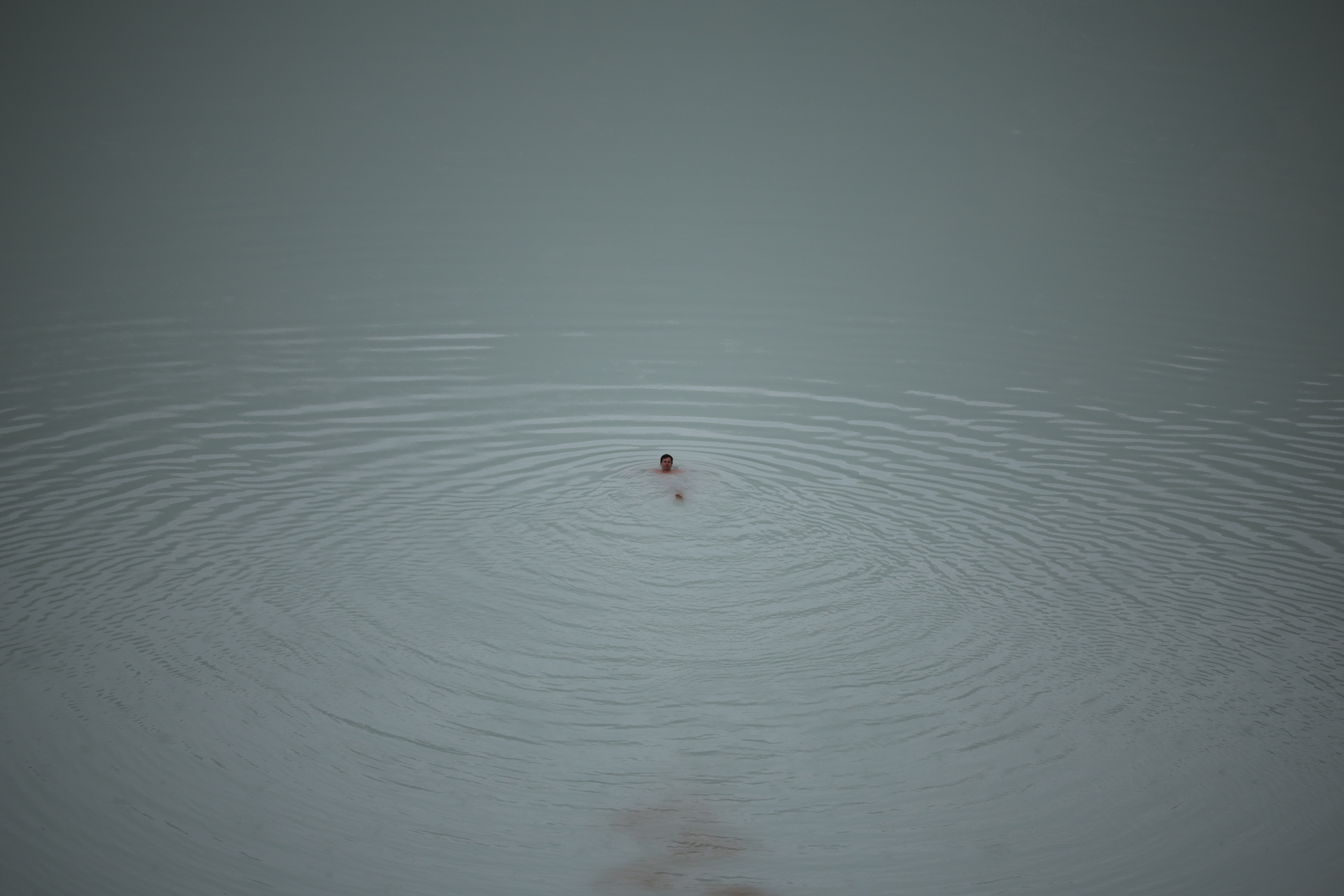 Tourists sometimes take a plunge in Viti crater’s lake despite warnings of acidic water and rockfall. Photo: Reuters