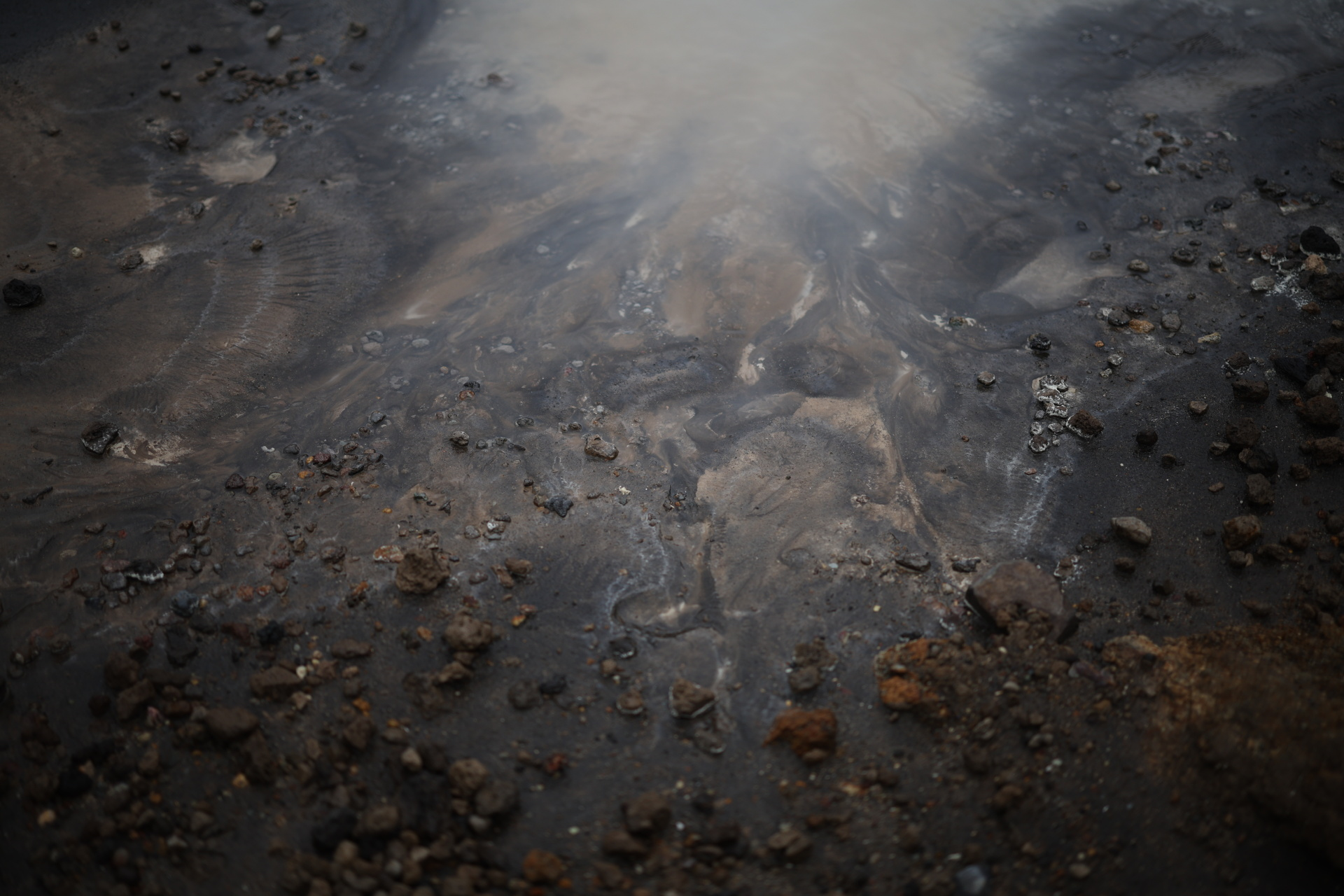 Warm, acidic water laps the rock-strewn shore of Viti’s crater lake. Photo: Reuters