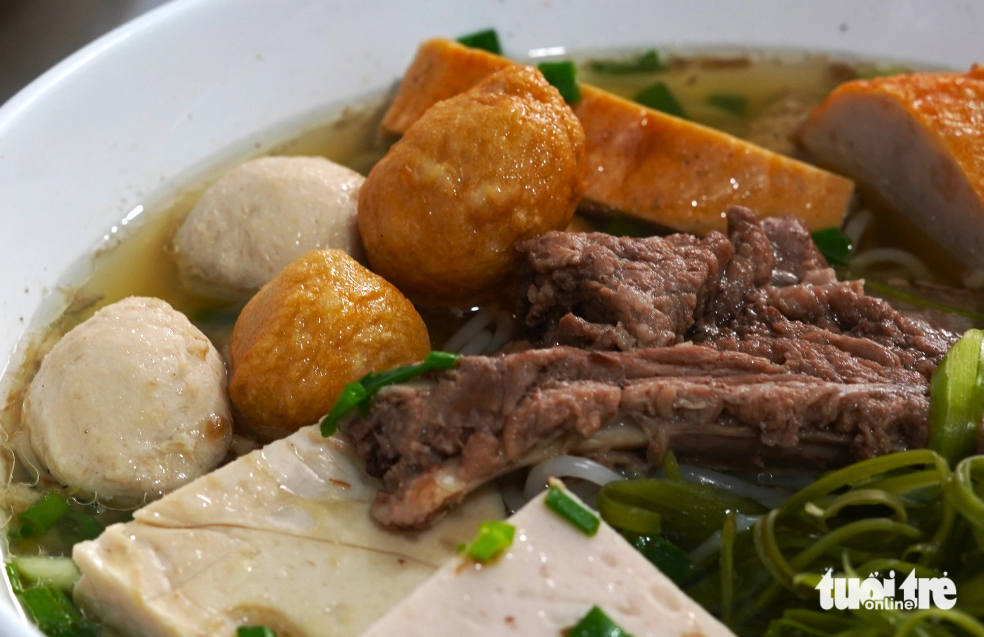 Meat, 'mọc' (pork balls), and 'chả' (pork rolls) in a bowl of 'bún mọc' (Vietnamese pork ball vermicelli soup) at Mrs. Chieu's restaurant on Bac Hai Street in Tan Binh District, Ho Chi Minh City. Photo: Tri Nhan / Tuoi Tre