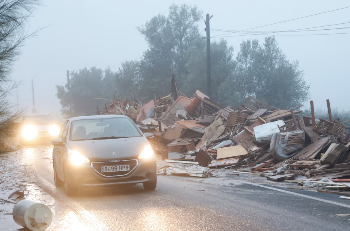 Cars move past damaged items from a furniture factory affected by torrential rains that caused flooding in La Alcudia, Valencia region, Spain, October 30, 2024. Photo: Reuters