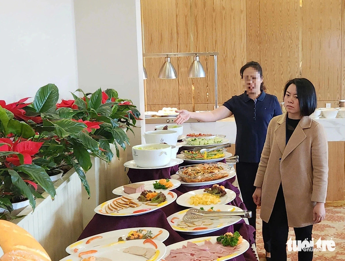 A member of the interagency team (R) inspects the restaurant of N.L. Hotel in Da Lat, Lam Dong Province. Photo: M.V. / Tuoi Tre