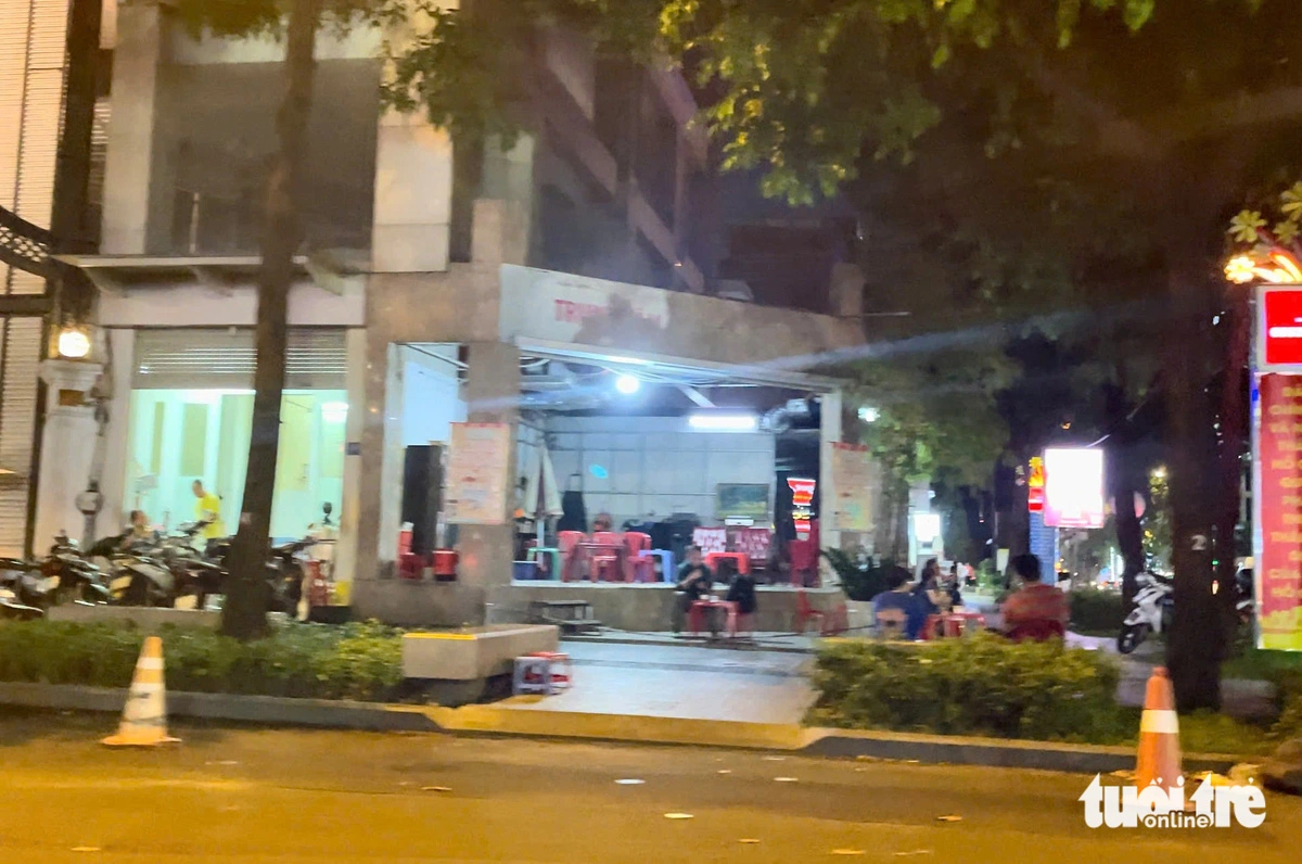 An eatery near Turtle Lake in District 3, Ho Chi Minh City places five traffic cones on the street to save space for customer parking. Photo: Dieu Qui / Tuoi Tre