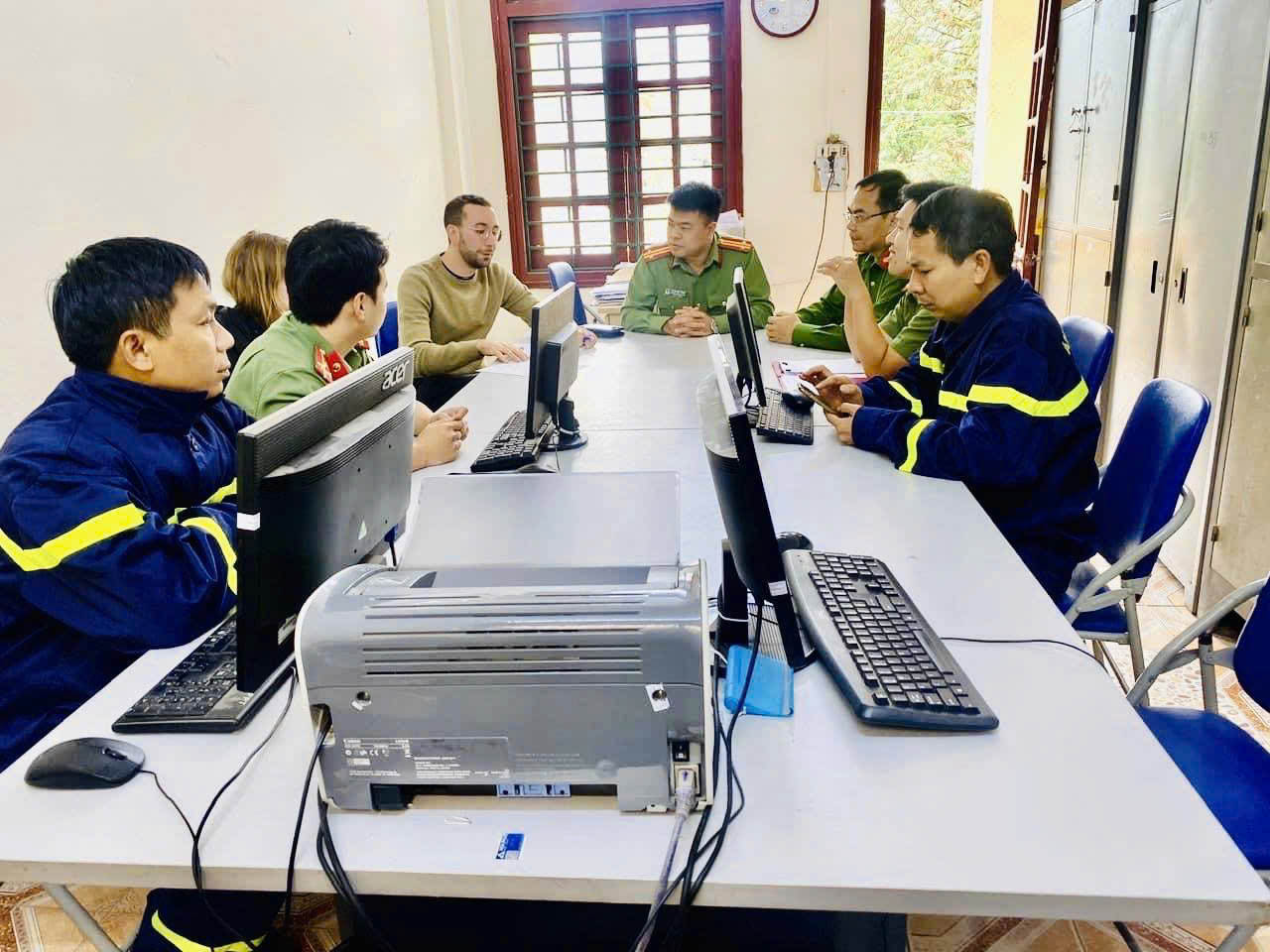 Bryan Handelman, a Swiss man, (L, 4th) is seen at a police station of Sa Pa Town, Lao Cai Province, northern Vietnam, after being rescued from a forest in the Hoang Lien National Park in northern Vietnam, on November 5, 2024. Photo: Thanh Tuan / Tuoi Tre