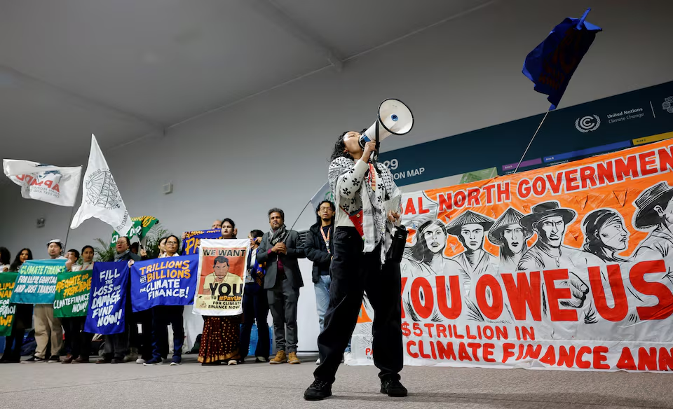 An activist speaks into a megaphone at a protest during the United Nations Climate Change Conference (COP29), in Baku, Azerbaijan November 14, 2024. Photo: Reuters