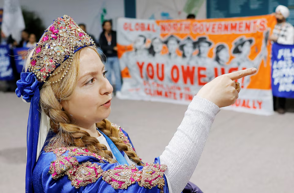 A woman dressed in traditional clothing attends a protest during the United Nations Climate Change Conference (COP29), in Baku, Azerbaijan November 14, 2024. Photo: Reuters