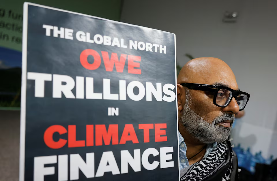 An activist holds up a sign at a protest during the United Nations Climate Change Conference (COP29), in Baku, Azerbaijan November 14, 2024. Photo: Reuters