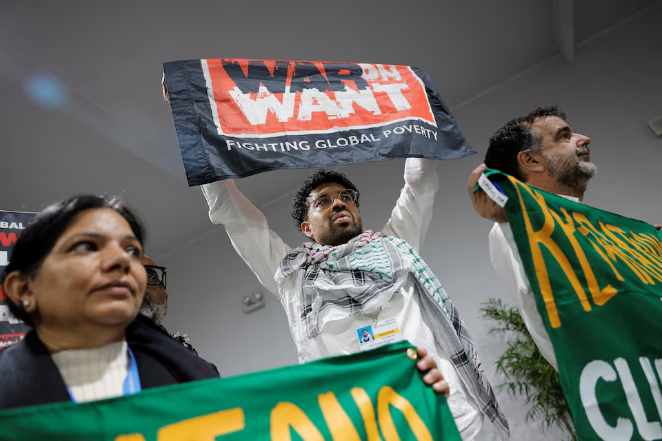 Activists hold up signs at a protest during the United Nations Climate Change Conference (COP29), in Baku, Azerbaijan November 14, 2024. Photo: Reuters