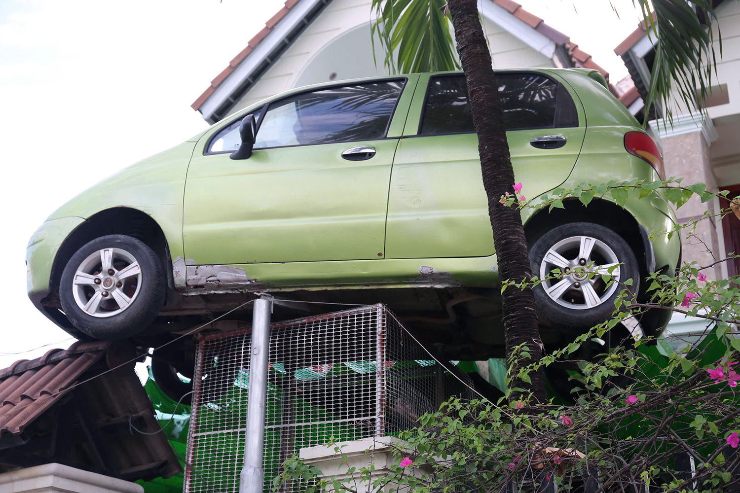 An old car is hung high in front of a house as a keepsake in Bien Hoa City, Dong Nai Province, southern Vietnam. Photo: A.B. / Tuoi Tre