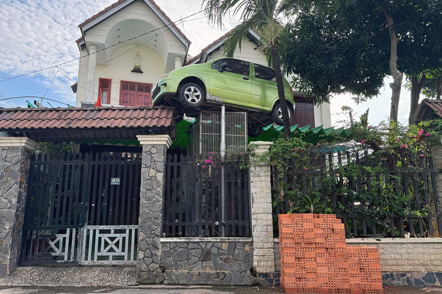 An old car is hung high in front of a house as a keepsake in Bien Hoa City, Dong Nai Province, southern Vietnam. Photo: A.B. / Tuoi Tre