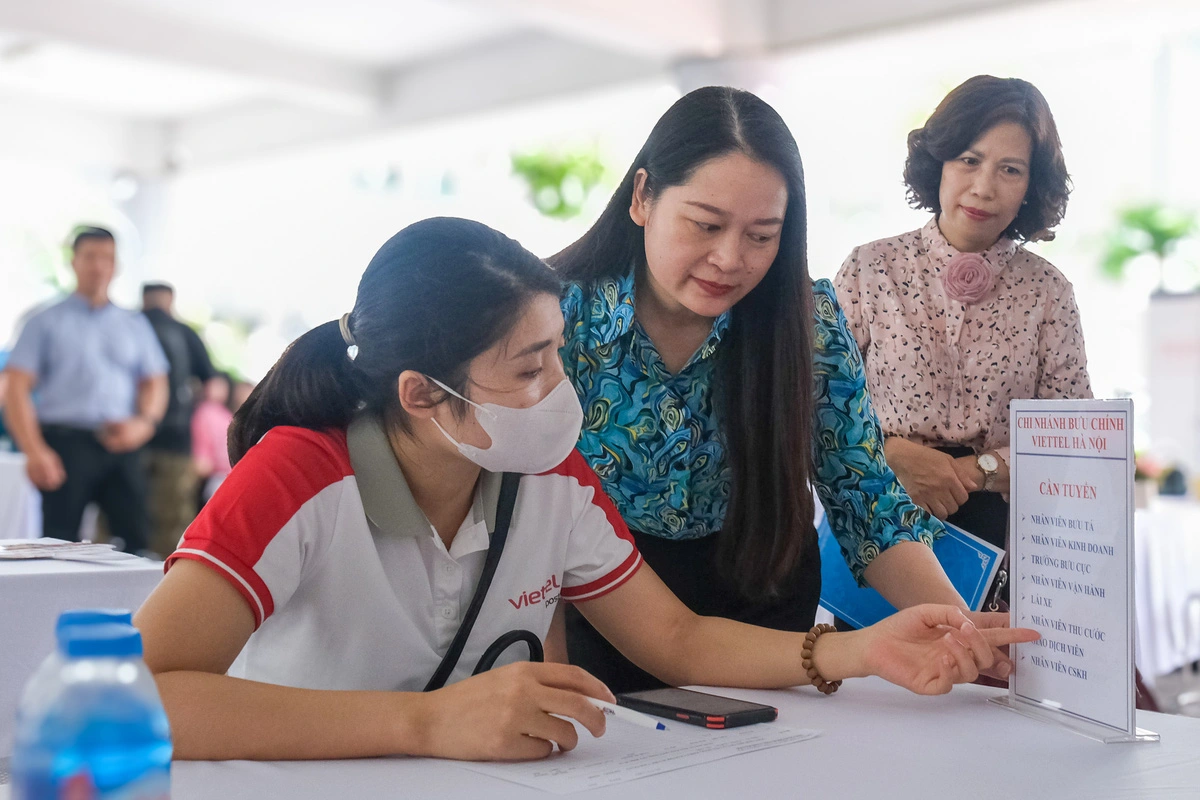 Pham Thi Diem (C), vice-chairwoman of the People’s Committee in Ba Dinh District, Hanoi, questions an employer about her company’s requirements for young candidates. Photo: Ha Quan / Tuoi Tre