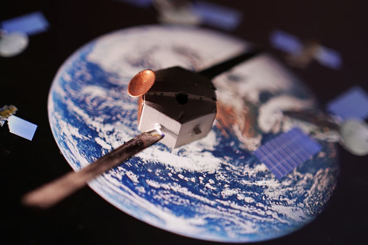 A satellite model is placed on a picture of Earth in this illustration taken November 25, 2024. Photo: Reuters