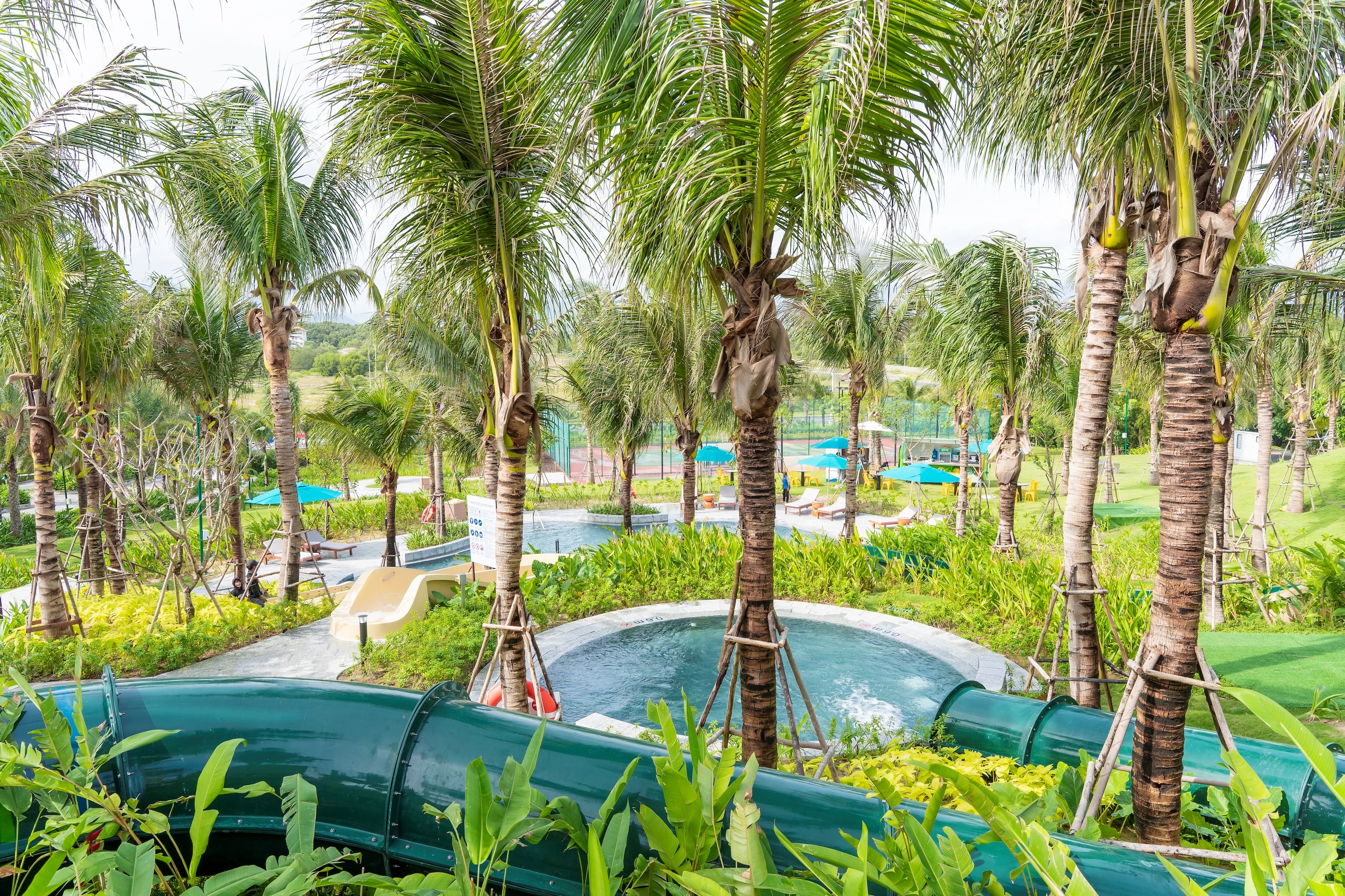 A lush tropical rainforest ambiance surrounds the waterpark.