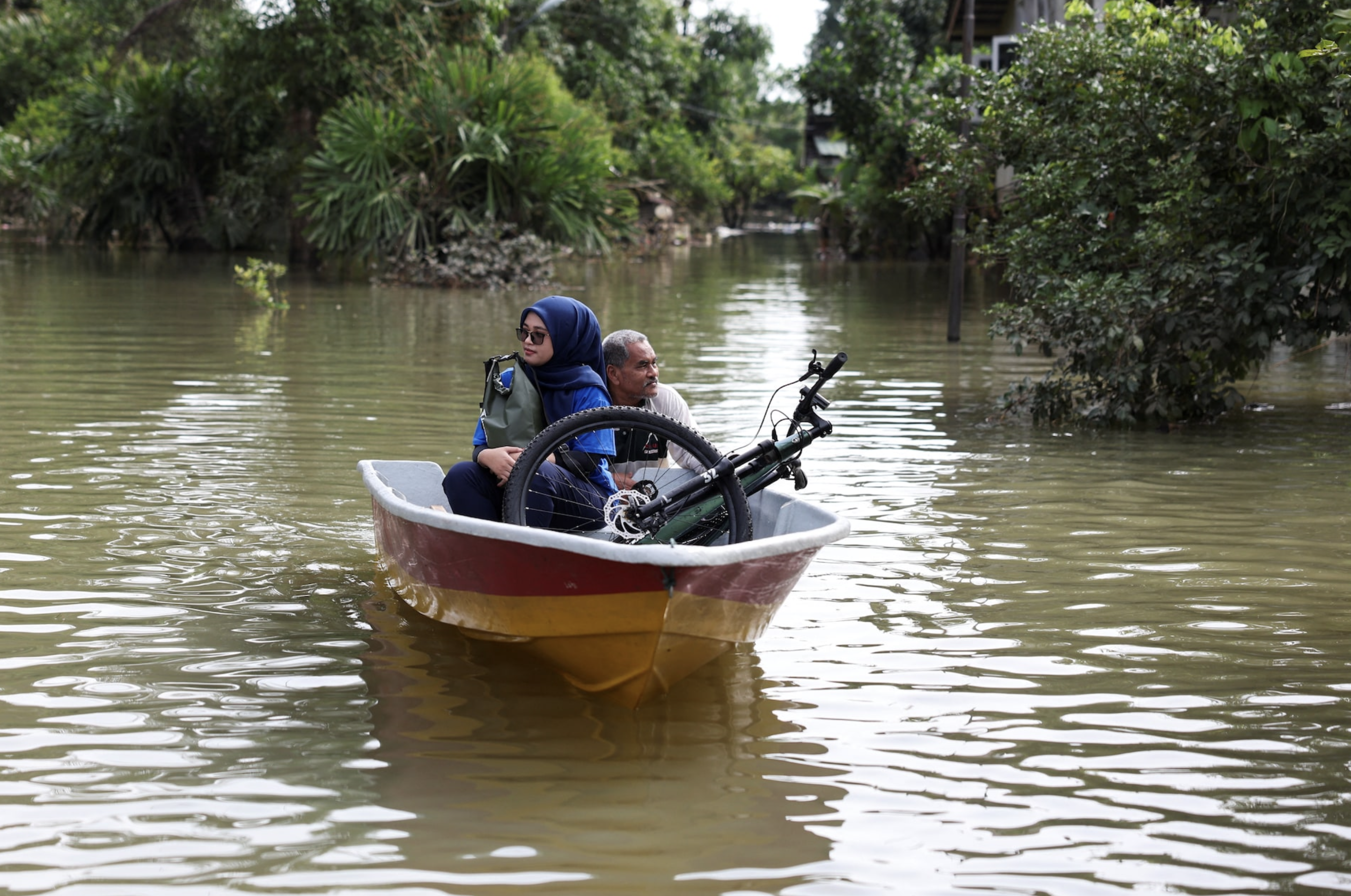 Clean-up begins in Malaysia towns hit by six months of rain in five days