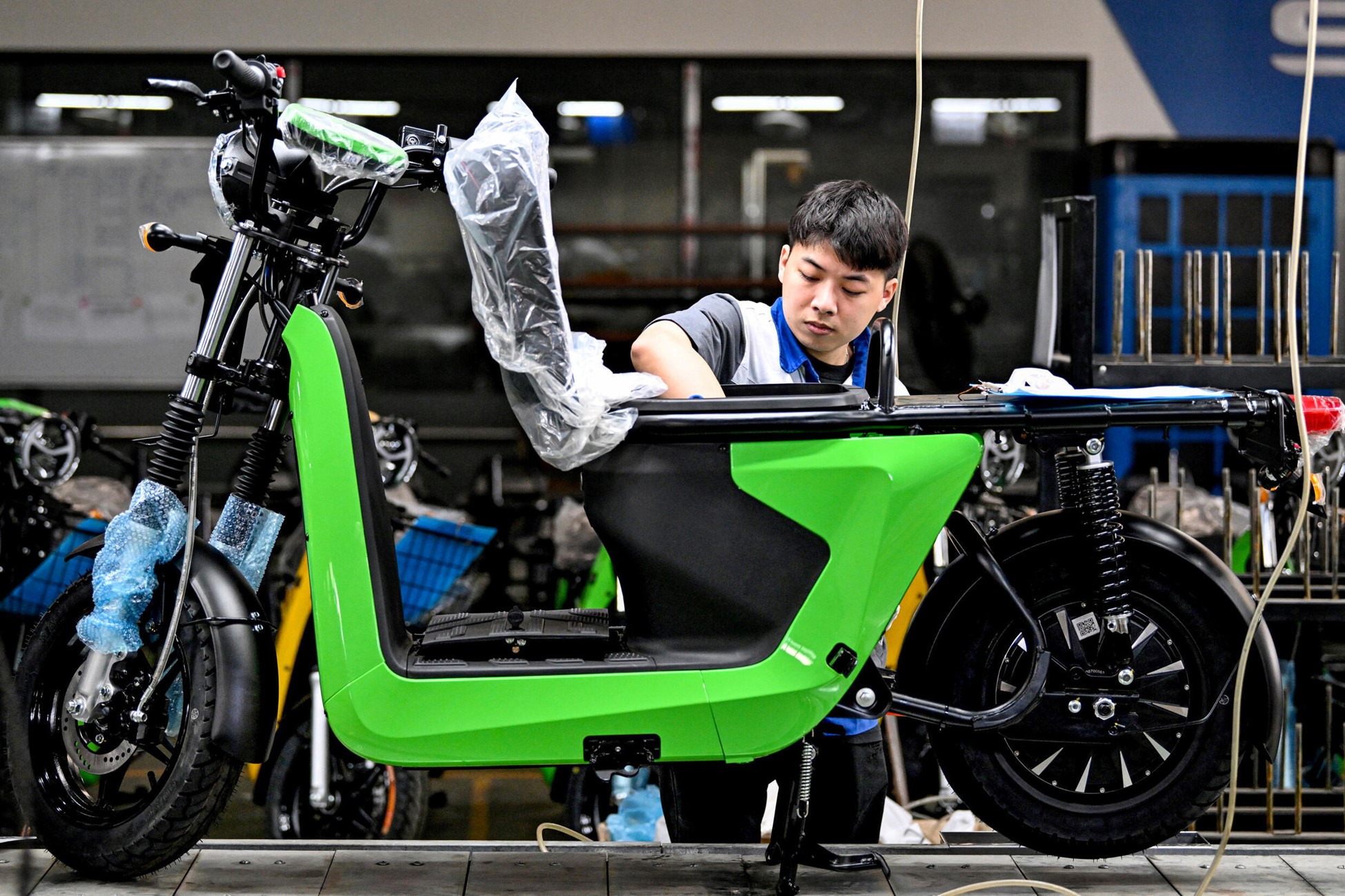 A worker assembles electric motorbikes at the Selex factory in Hanoi. Photo: AFP