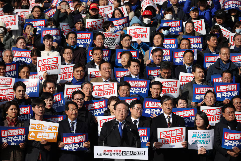 [3/11]South Korea's main opposition Democratic Party leader Lee Jae-myung looks on as people hold placards that read 'Step down President Yoon Suk Yeol' and 'Investigate his act of rebellion immediately', at a rally to condemn South Korean President's surprise declarations of the martial law last night and to call for his resignation, at the national assembly in Seoul, South Korea, December 4, 2024. Photo: Reuters