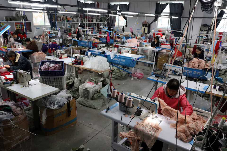 [7/10]Employees work with sewing machines on the production line of the Midnight Charm Garment lingerie factory in Guanyun county of Lianyungang, Jiangsu province, China November 25, 2024. Photo: Reuters