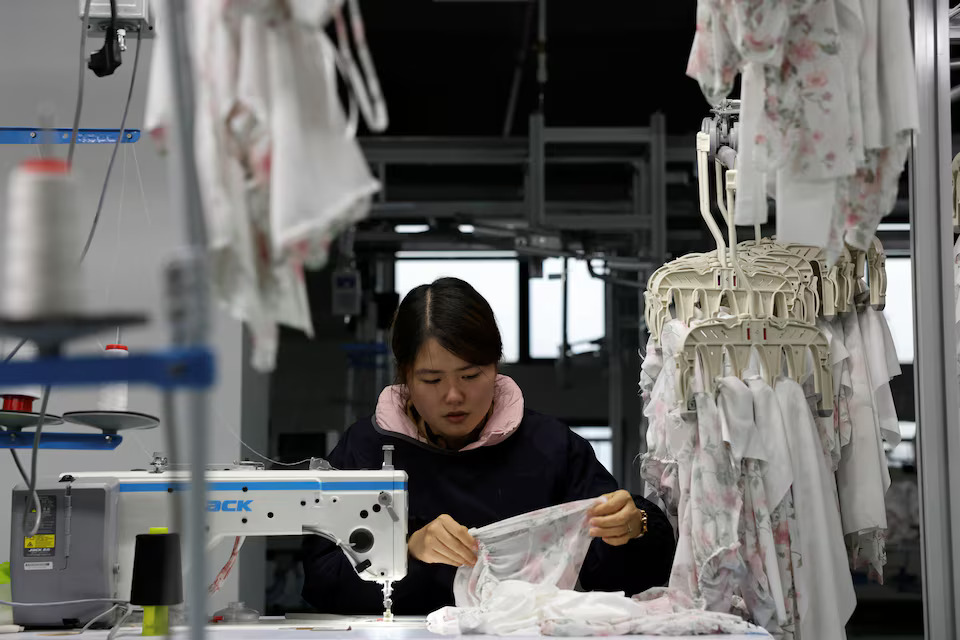 [8/10]An employee works on the production line of a lingerie factory at WeMet Industrial Park, in Guanyun county of Lianyungang, Jiangsu province, China November 25, 2024. Photo: Reuters