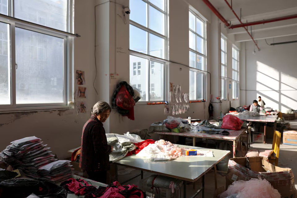 [4/10]A 72-year-old employee works at the Midnight Charm Garment lingerie factory in Guanyun county of Lianyungang, Jiangsu province, China November 26, 2024. Photo: Reuters